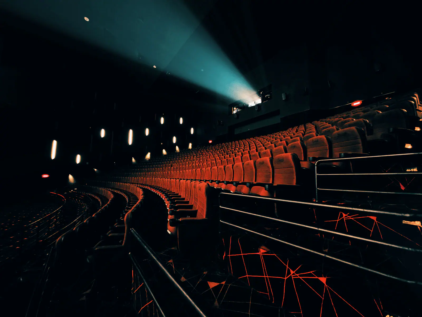Auditorium with a projector beam and dramatic lighting