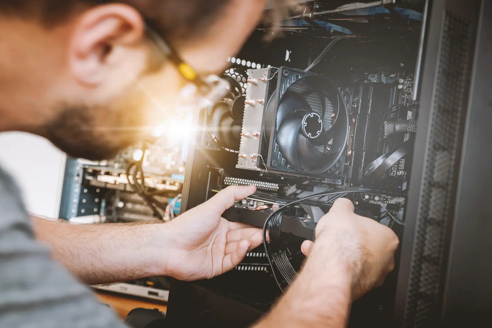 Engineer working on the inside of a computer