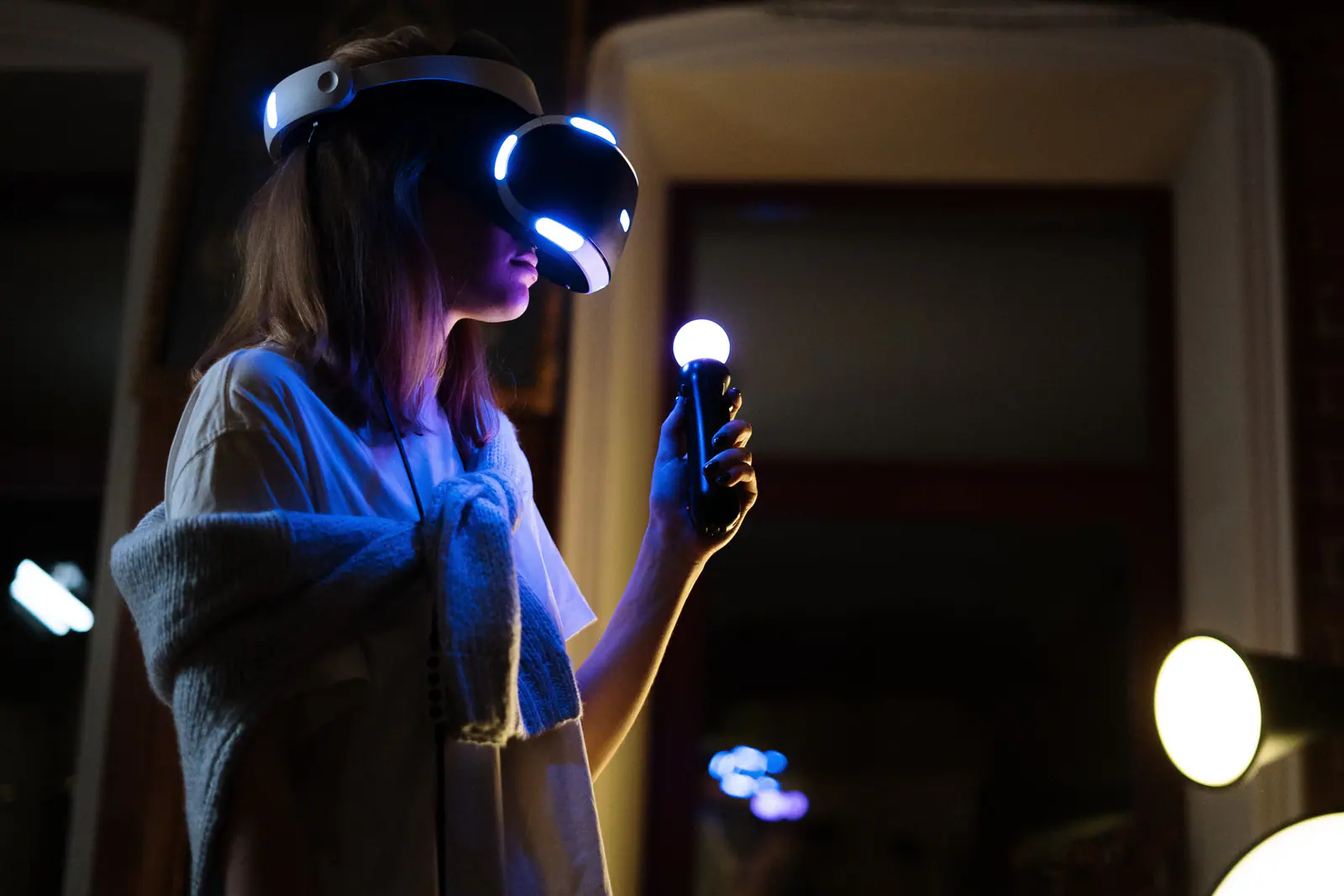 Visitor wearing a VR headset and holding motion controllers